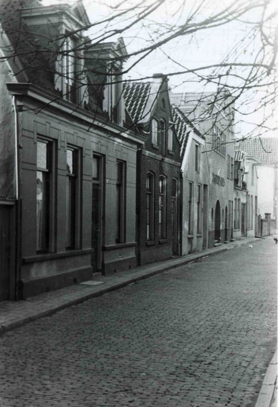 Achter 't Hofje met zicht op enige panden, vierde pand met boog links is Leger des Heils. feb. 1944.jpg