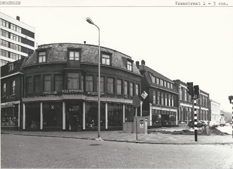 Veenstraat 1, 3, 5 hoek Lipperkerkstraat met meubel- en tapijtzaak Kelderman. Links drogisterij H. Bergsma en rechts de fabriek van Blenken 8-5-1980.jpg