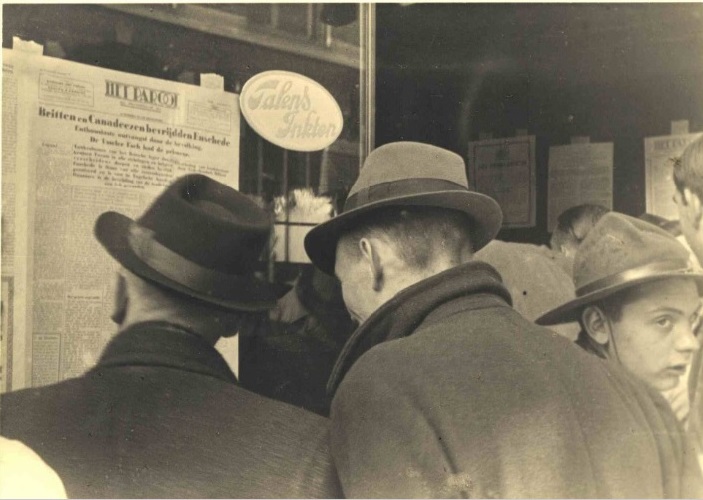 Haaksbergerstraat, mensen bekijken Het Parool met nieuws over de bevrijding van Enschede..jpg