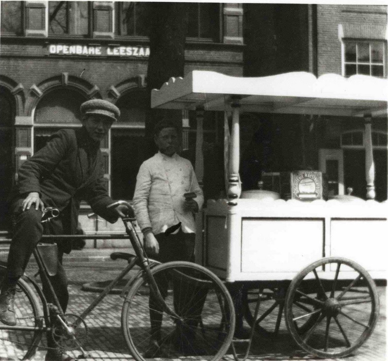 Markt 13-14 IJsverkoper met ijskar, Openbare Leeszaal op achtergrond 1920.jpg